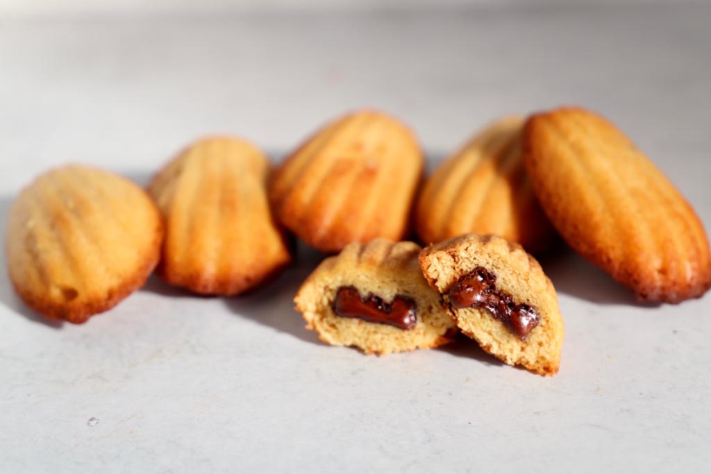 Indulge in the rich and decadent flavor of vegan madeleines filled with premium Valrhona chocolate, handcrafted by L'Artisane Creative Bakery.